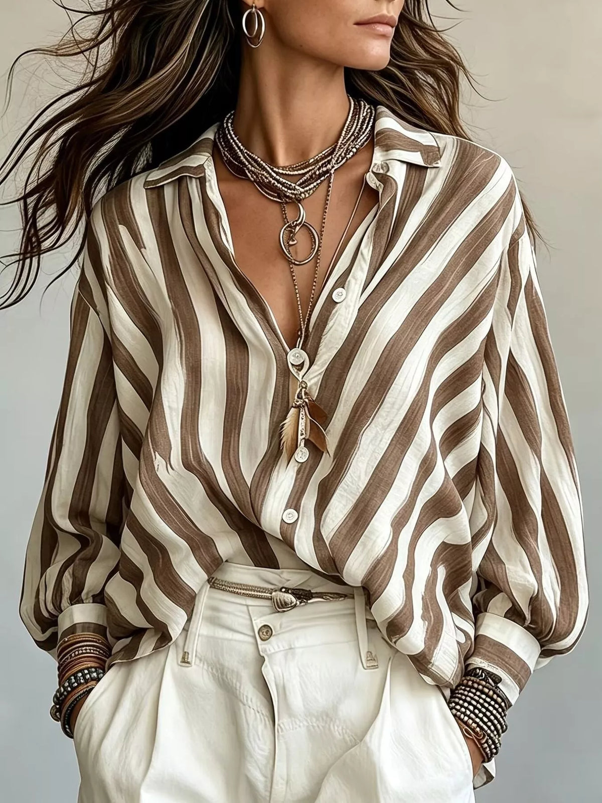 Women’s striped loose fit shirt by Trendsi featuring a casual, relaxed fit with vertical stripes in various colors.