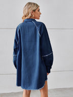 VYSN raw hem button-up denim dress displayed on a hanger, featuring a classic collar, long sleeves, and a casual, stylish fit.