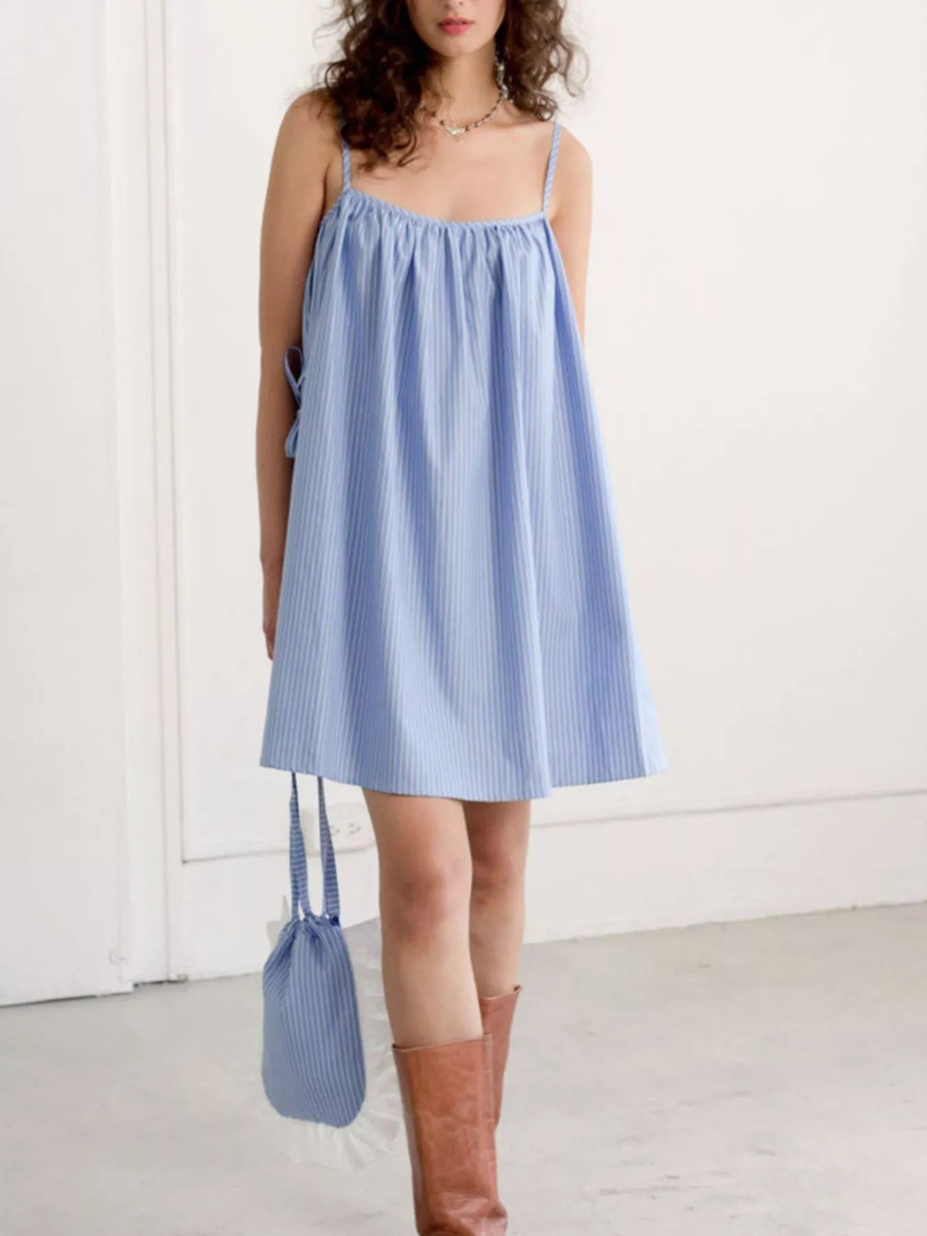 Polka dot spaghetti strap mini dress by Shopimist, featuring a fitted bodice and flared skirt with a playful pattern.