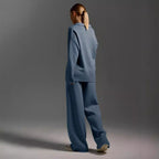 Women’s fall winter two-piece casual outfit by FitiqueFit featuring a loose collar sweater and matching pants.