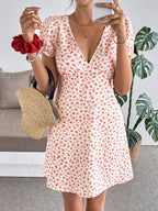 Floral print V-neck puff sleeve mini dress for women, casual summer dress by Trendsi, featuring a feminine floral pattern and short sleeves.