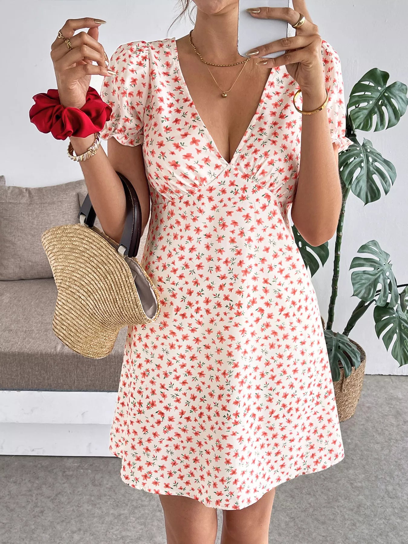 Floral print V-neck puff sleeve mini dress for women, casual summer dress by Trendsi, featuring a feminine floral pattern and short sleeves.