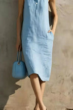 Casual sleeveless midi dress with button details by Trendsi, featuring a relaxed fit and stylish design.