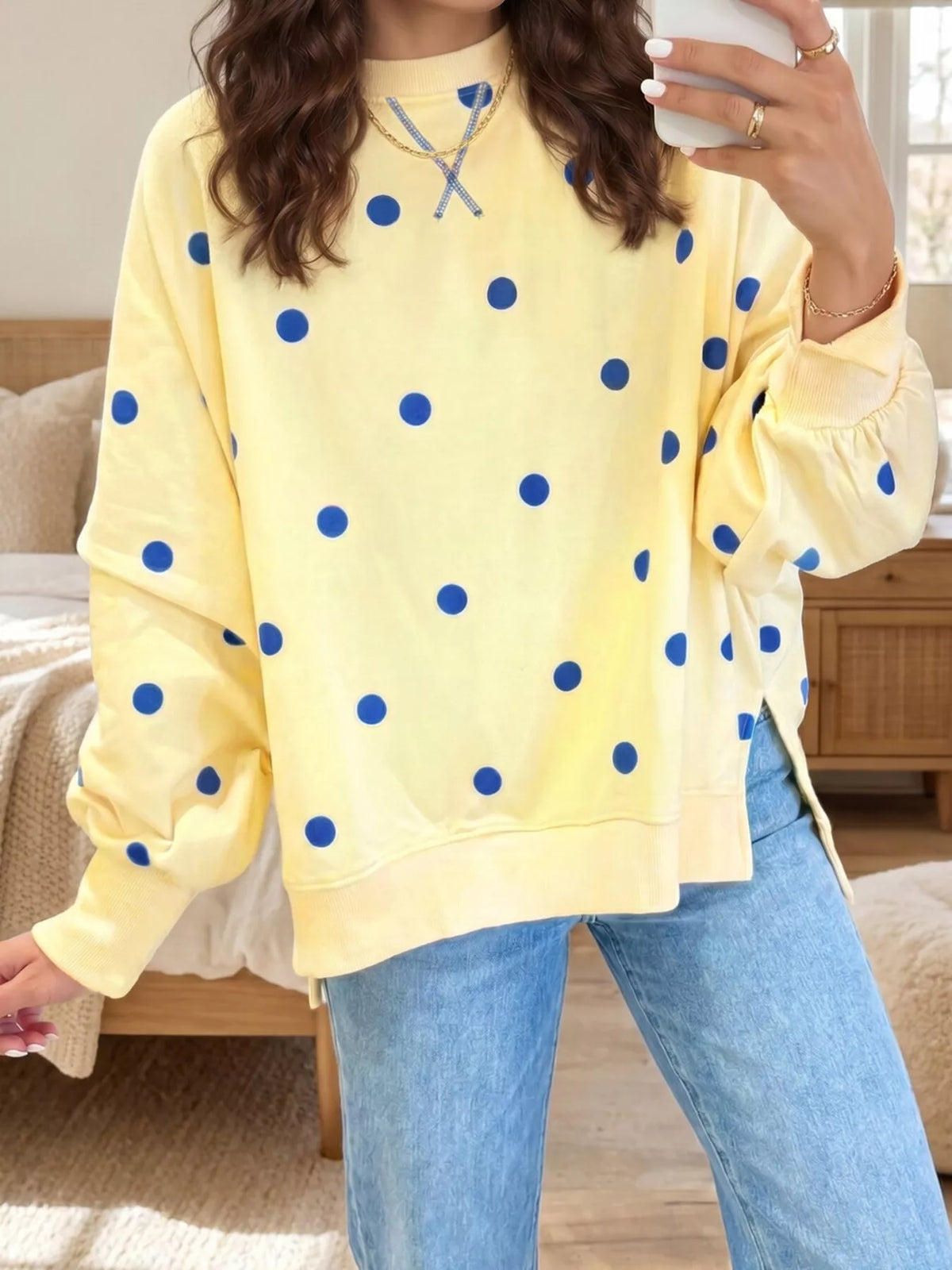 Oversized polka dot sweatshirt with side slit from Trendsi, featuring a relaxed fit and stylish pattern.