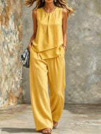 Women's sleeveless two-piece set by Plush Fashion Hub featuring solid color wide-leg pants and matching top.