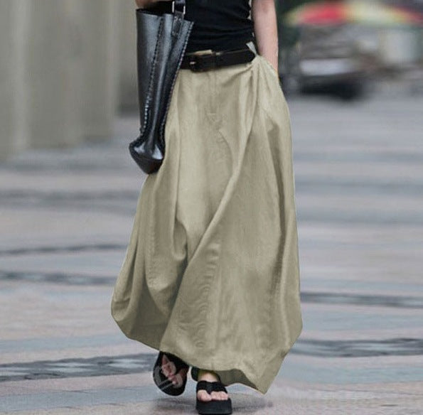 Women's high-waist flared maxi skirt in solid cotton linen with pockets, by Plush Fashion Hub, shown in natural fabric texture.