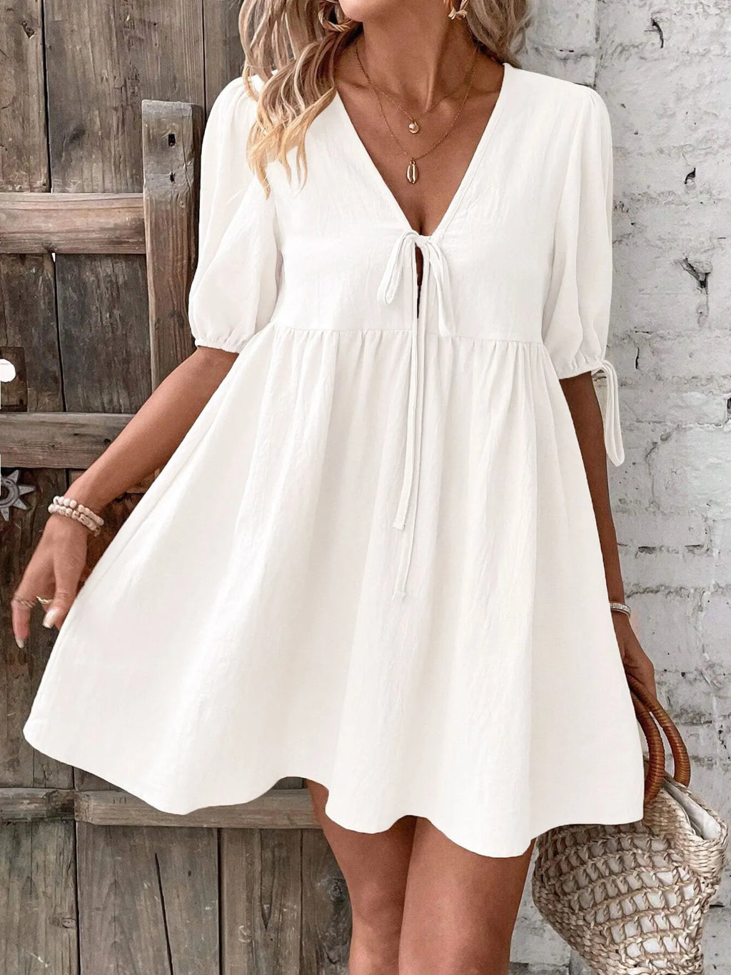 Cotton V-neck tie-front mini dress with puff sleeves, stylish and comfortable, from Trendsi.