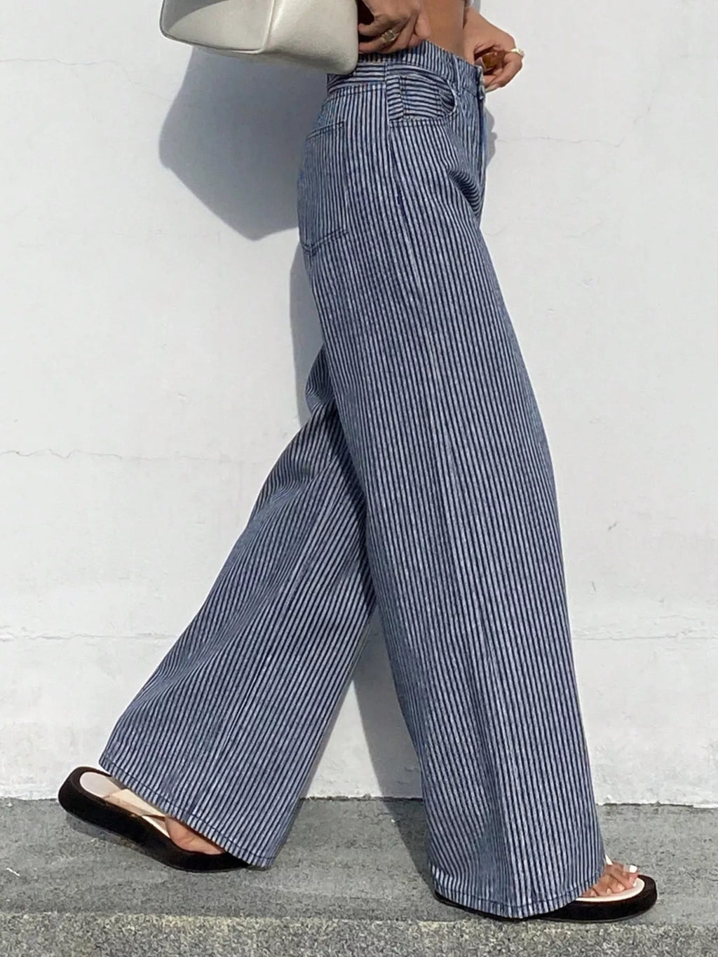 Striped wide-leg jeans by Shopimist featuring a high waist and relaxed fit, shown in a front view with bold vertical stripes.