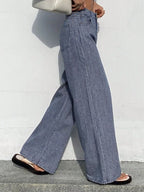 Striped wide-leg jeans by Shopimist featuring a high waist and relaxed fit, shown in a front view with bold vertical stripes.