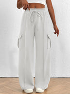 Lightweight women's high-waisted casual cargo pants with drawstring waistband, featuring utility-style pockets in neutral tones.