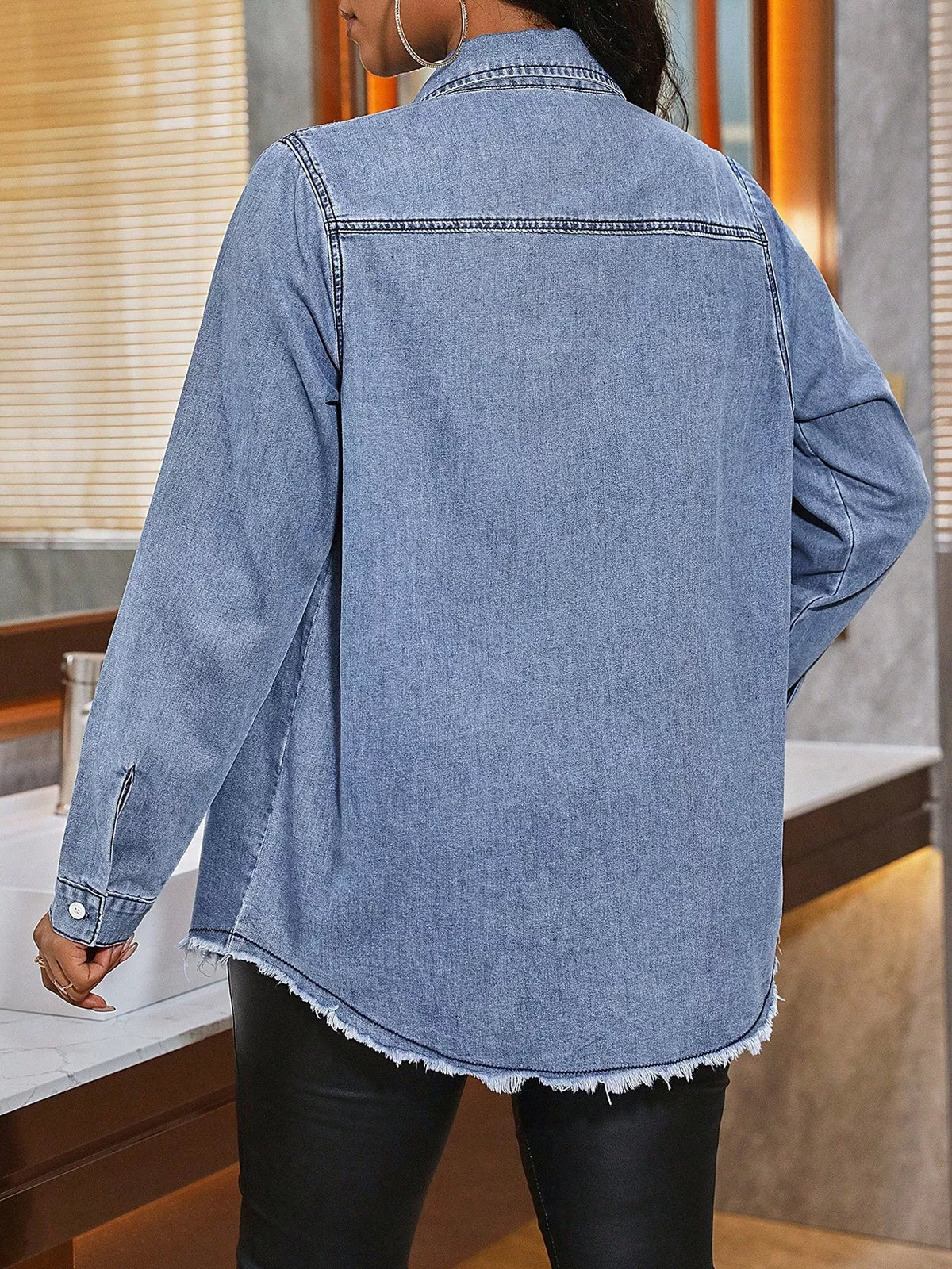Raw hem button-up denim shirt by Plush Fashion Hub, featuring classic blue denim fabric, button front, and casual style.
