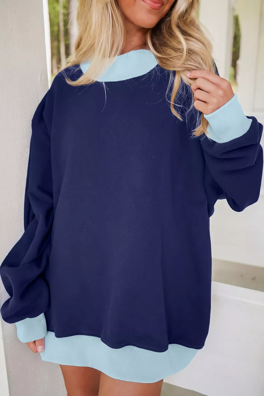 Colorblock trim crewneck long sleeve sweatshirt by Trendsi, featuring a stylish colorblock design and comfortable fit.