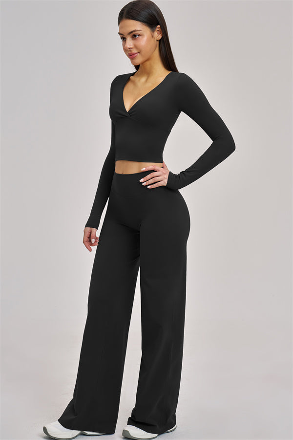 Fitglutes Activewear long sleeve crop top with fitted design, shown in stylish black for gym and workout sessions.