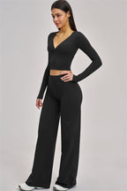 Fitglutes Activewear long sleeve crop top with fitted design, shown in stylish black for gym and workout sessions.