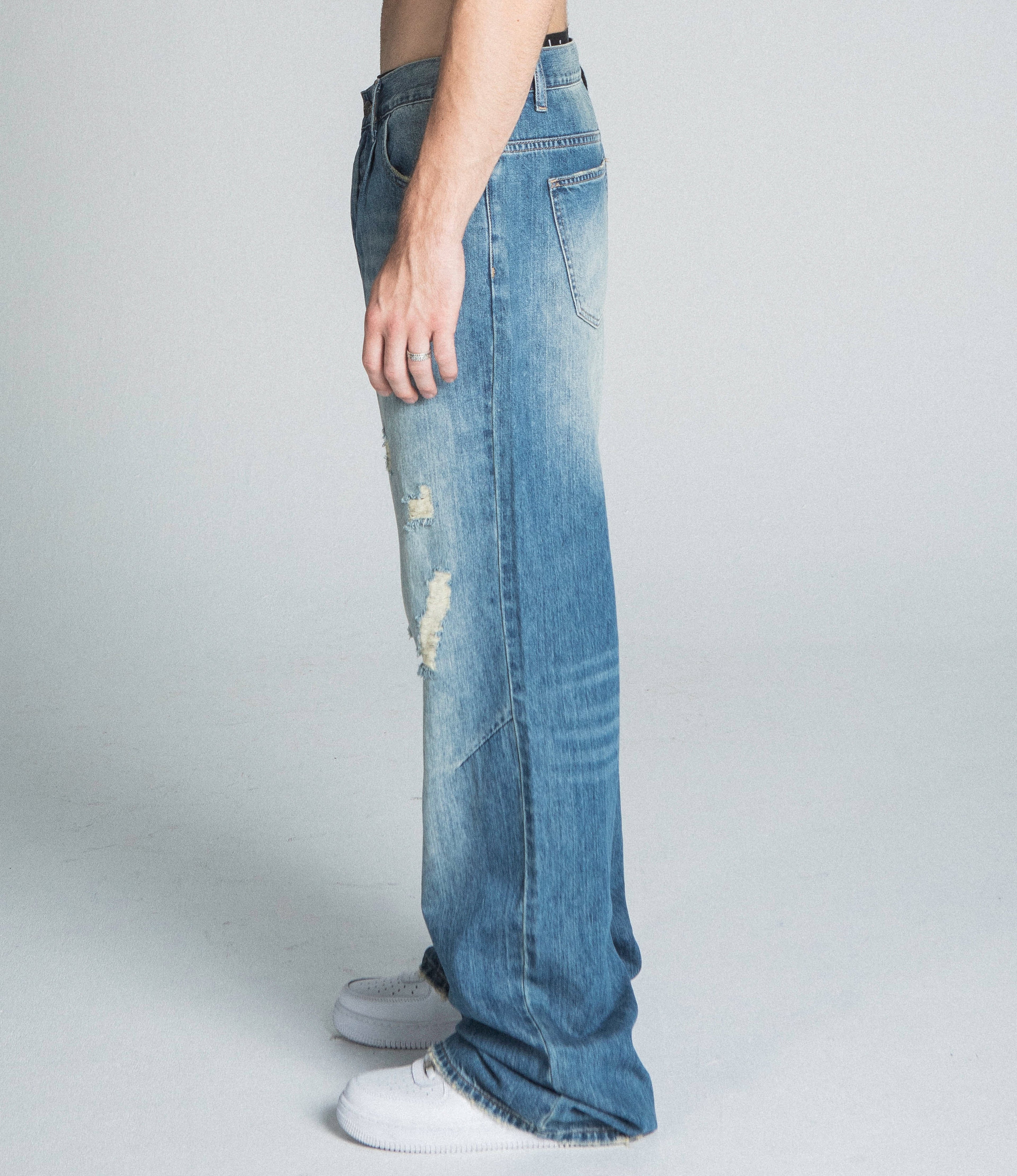 Lightly distressed blue baggy jeans from Armor Jeans, classic style, relaxed fit, and casual bottom wear.