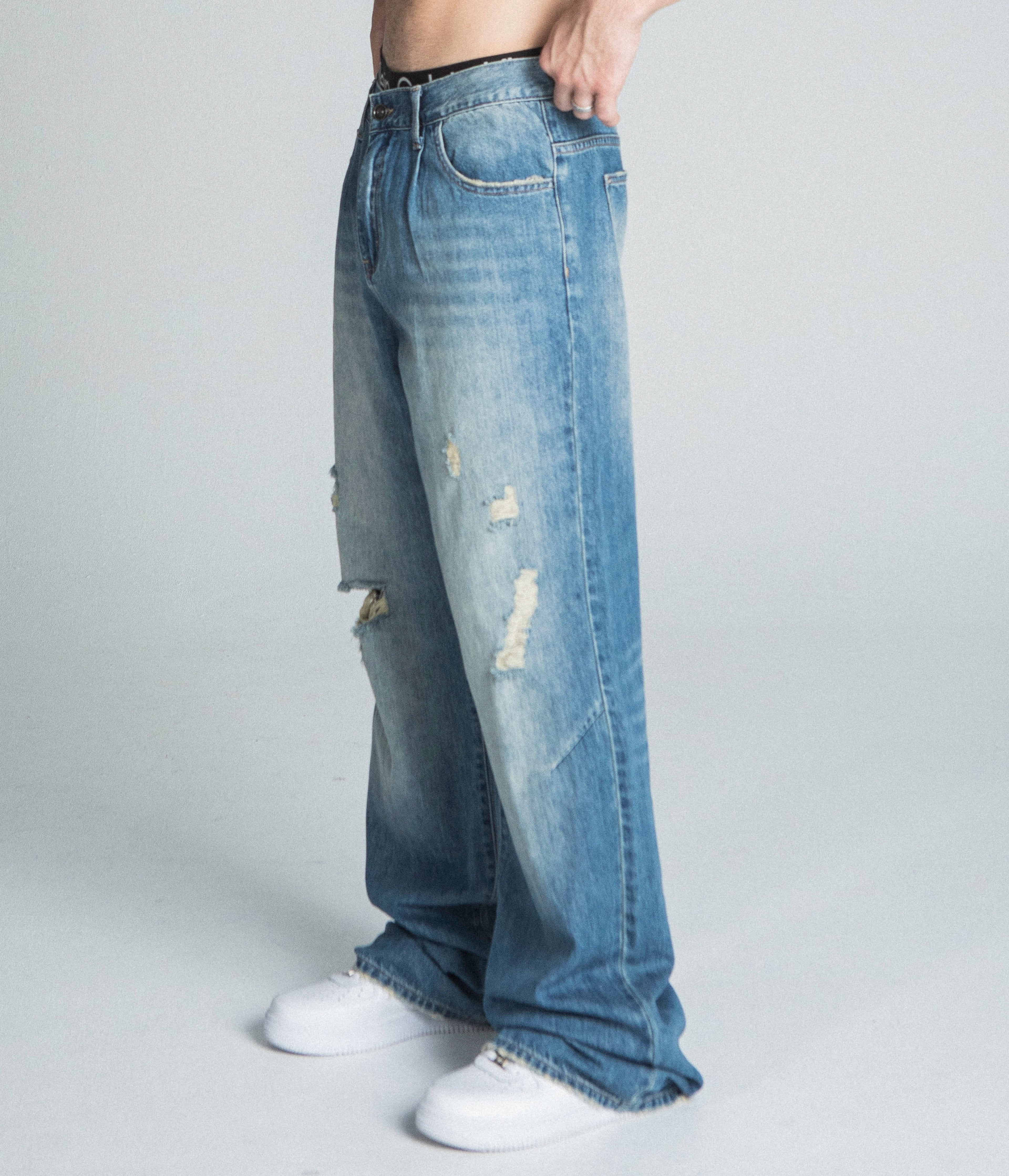 Lightly distressed blue baggy jeans from Armor Jeans, model AJ09-3, showcasing relaxed fit and casual style.