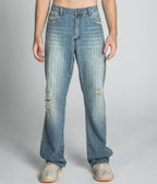 Blue ripped loose jeans by Armor Jeans, featuring distressed blue threads and a relaxed fit, shown on a model.