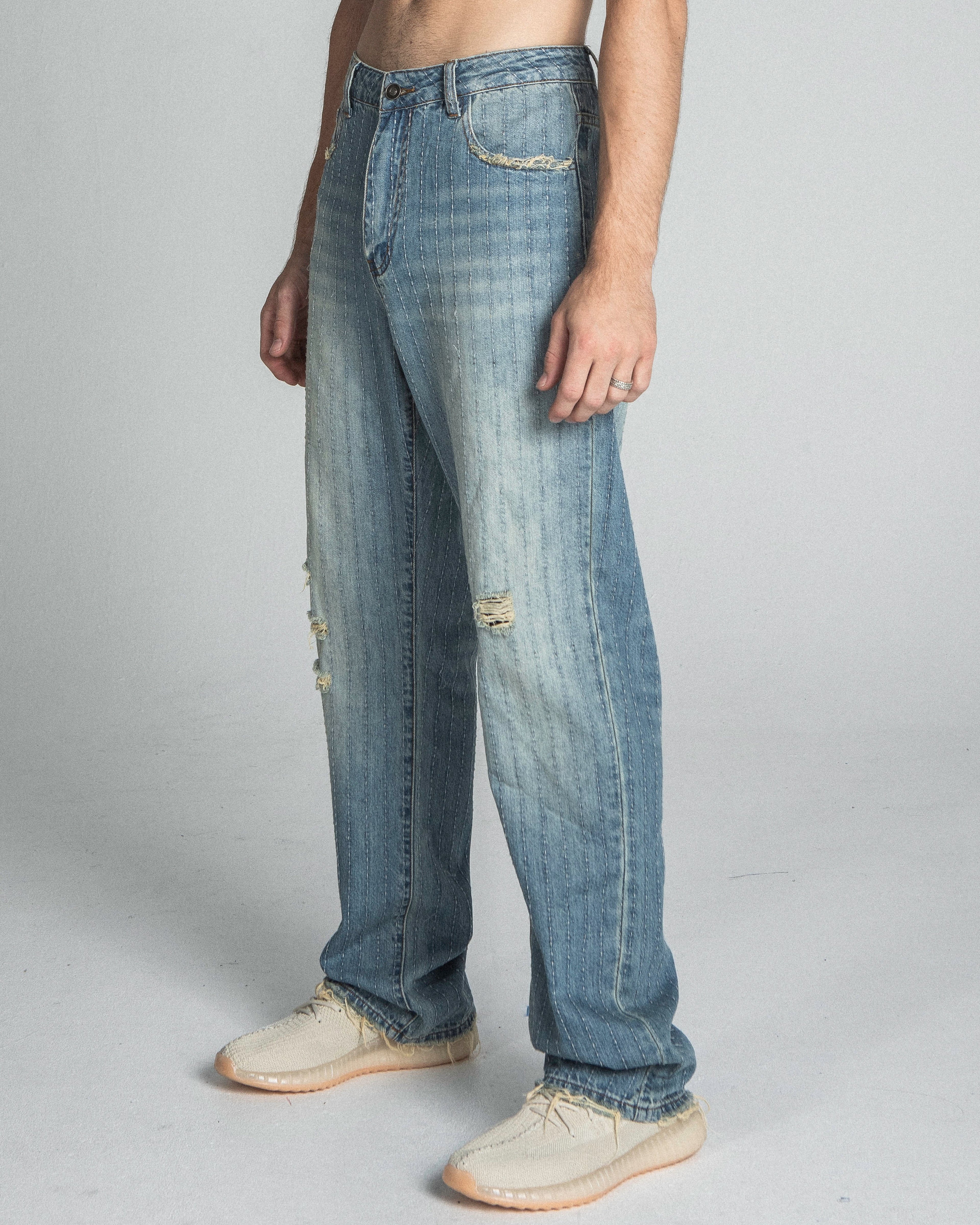 Blue ripped jeans with loose fit and distressed details from Armor Jeans AJ02L Ripped Blue Thread collection.