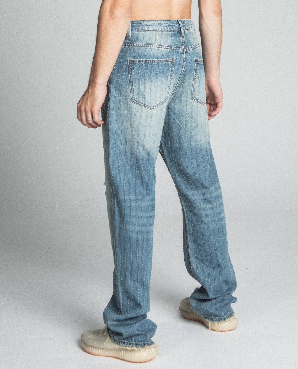 Ripped blue Thread loose jeans by Armor Jeans, stylish casual pants with distressed details and a relaxed fit.