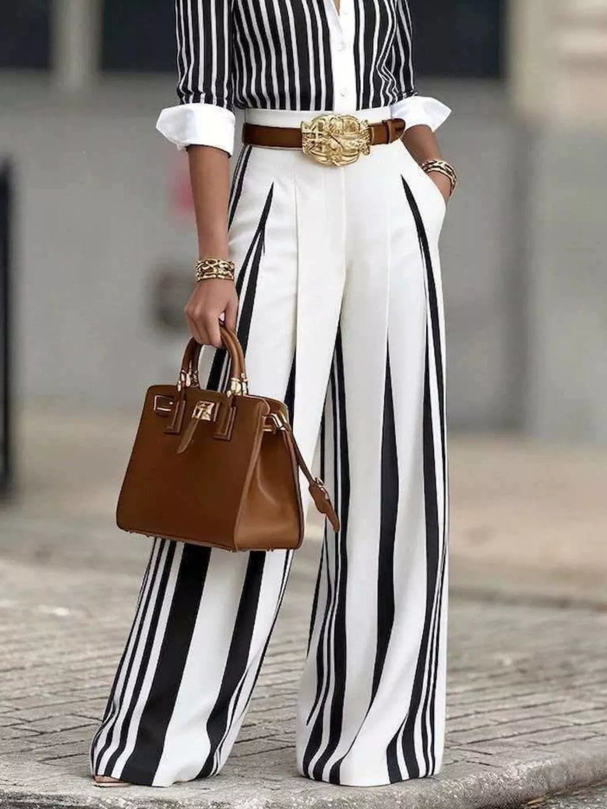 High-waisted wide-leg striped pants from Plush Fashion Hub with a relaxed fit and bold vertical stripe pattern.