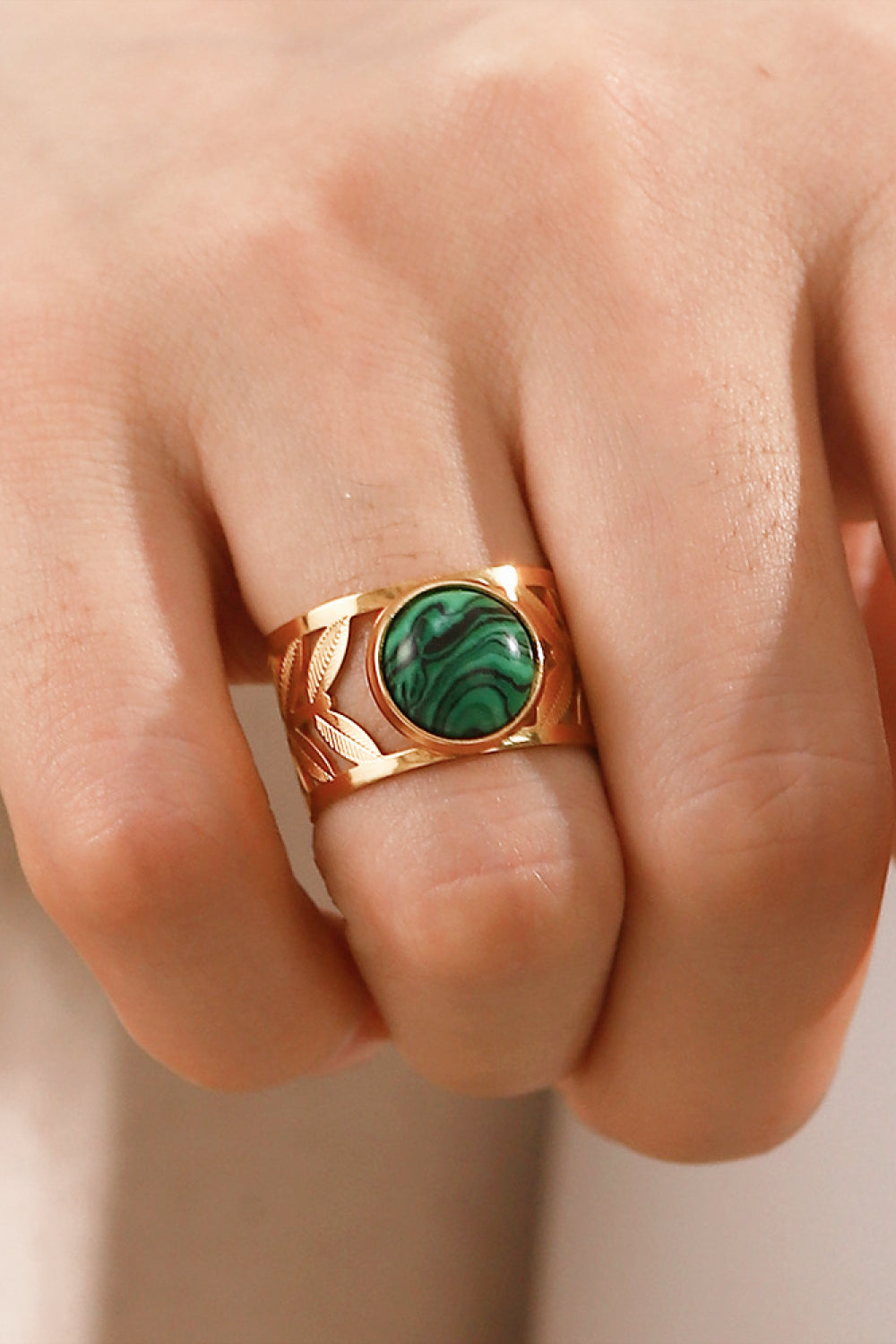 18k gold plated malachite leaf ring with detailed leaf design, showcasing vibrant green malachite gemstone on a gold band.