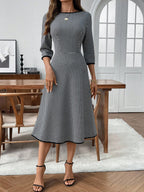 Classic plaid round neck midi dress with 3/4 sleeves from Trendsi, featuring a stylish, comfortable design perfect for casual wear.