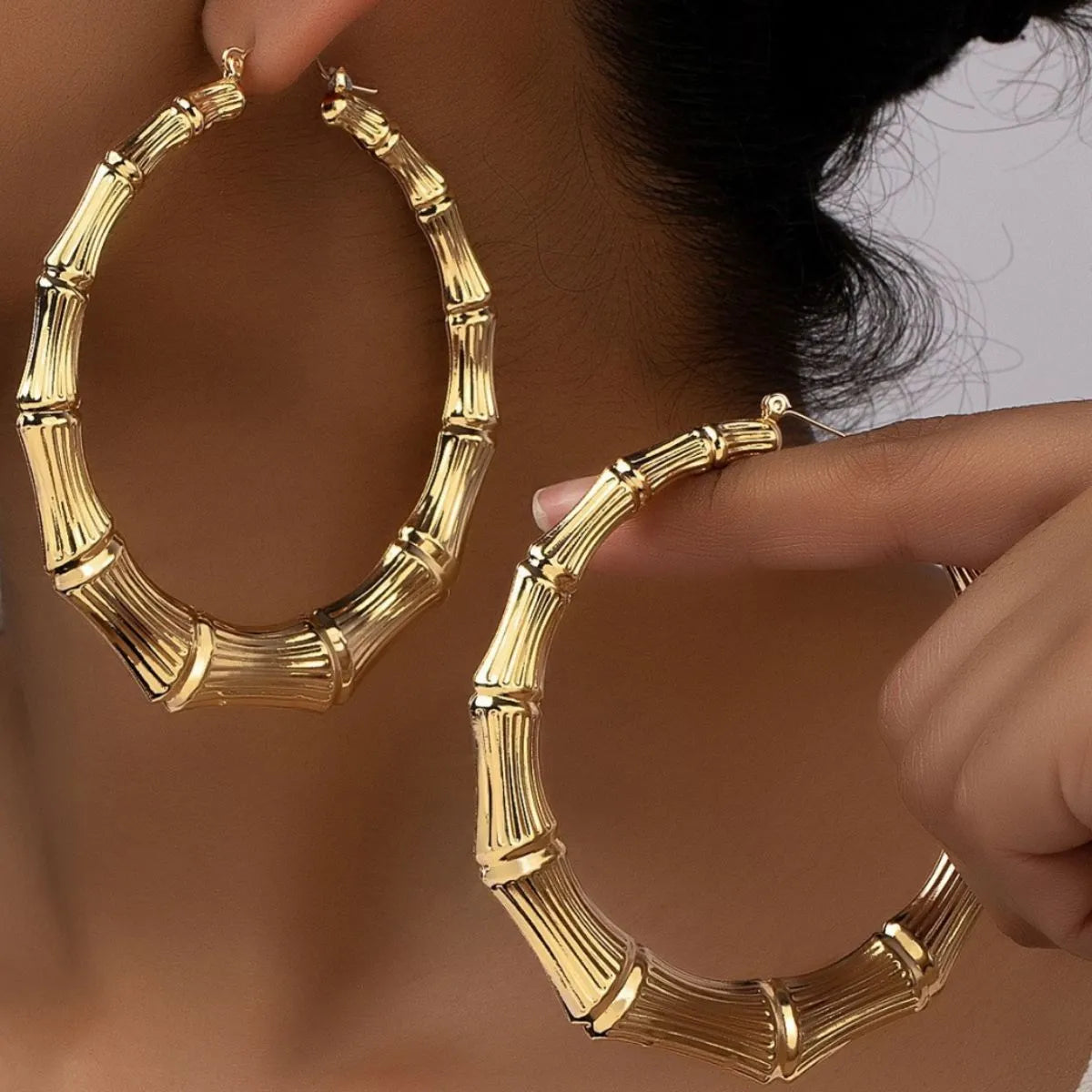 Stainless steel textured hoop earrings with a polished finish, stylish jewelry accessory for women.