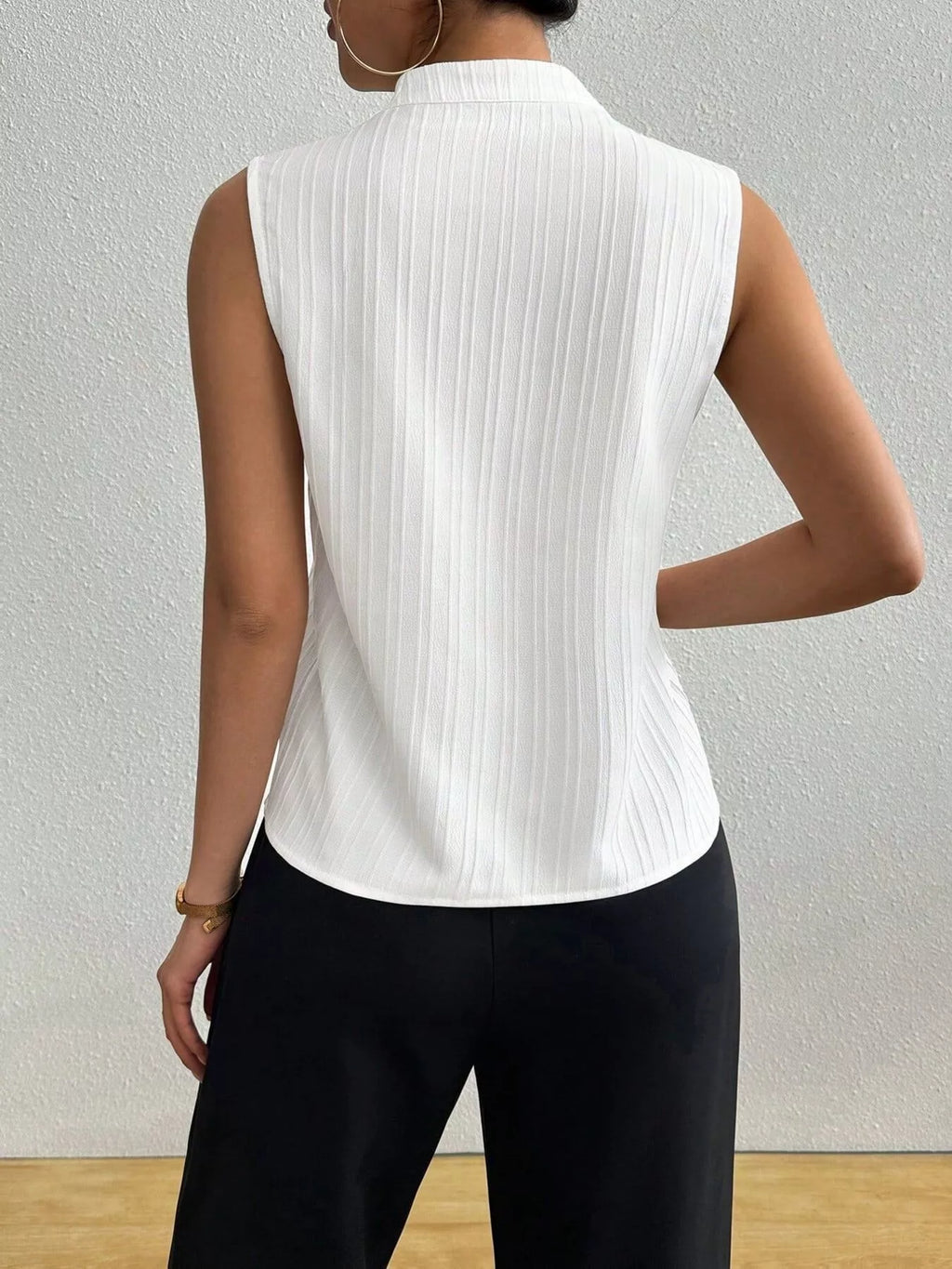 Women's textured notched neck sleeveless tank top from Trendsi, versatile basic shell, showcasing the stylish notch neckline and sleeveless design.