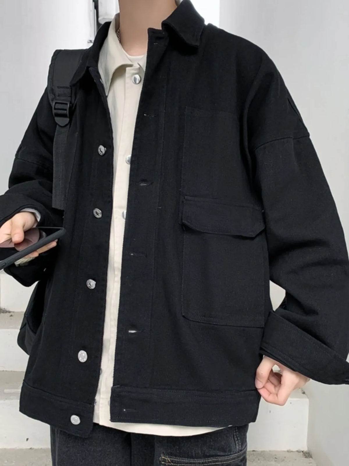 Men's denim jacket with drop shoulder design, button-up style, in a classic blue denim from Trendsi.