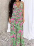 Printed halter neck maxi dress by Shopimist featuring vibrant floral patterns and flowing fabric, perfect for summer occasions.
