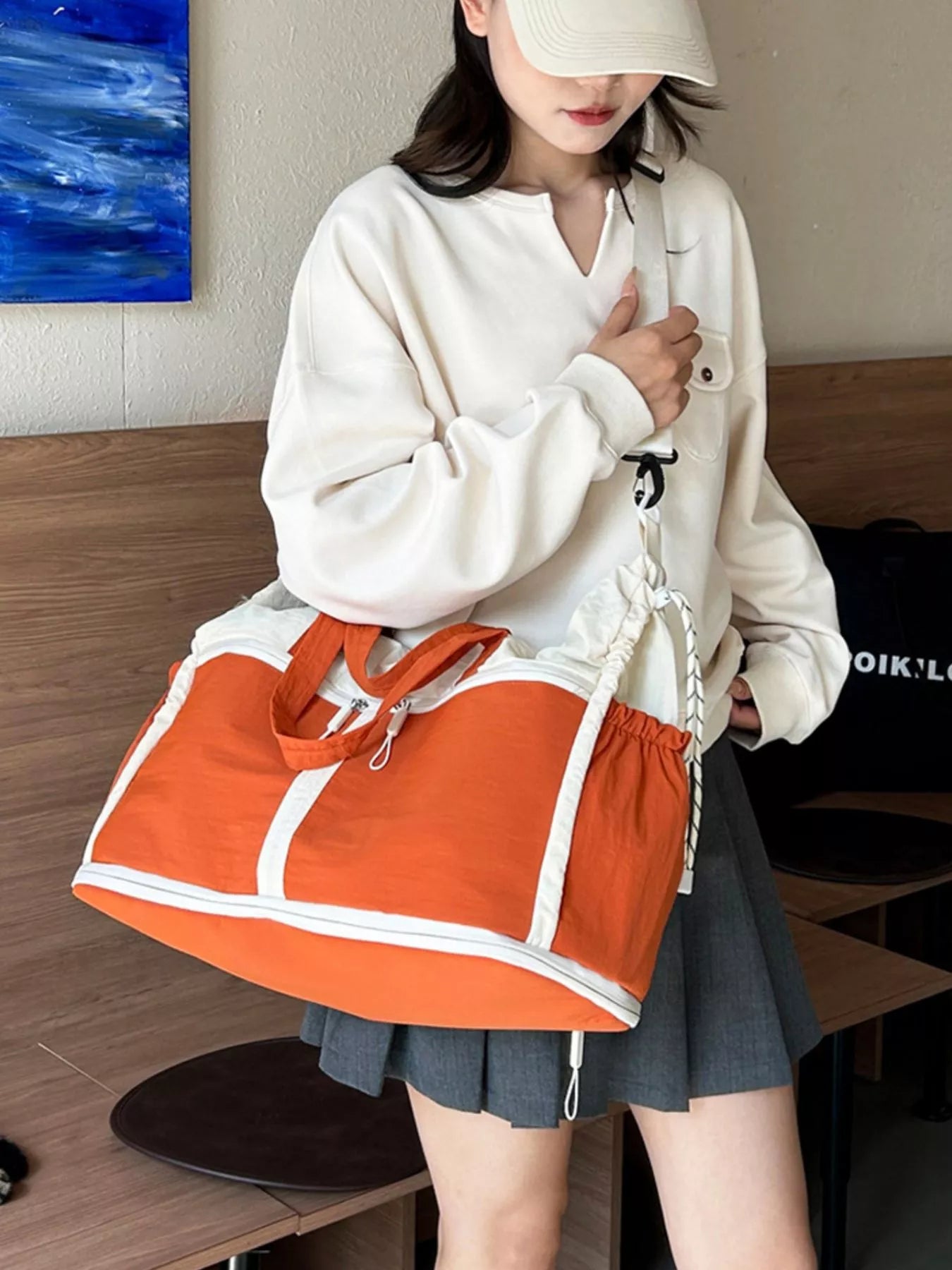 Color-block travel bag by Plush Fashion Hub, showing a vibrant, multi-colored design with sturdy handles and spacious interior.
