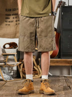 Plus size men's casual drawstring shorts by Trendsi with deep pockets, relaxed fit, comfortable fabric, shown in a casual setting.