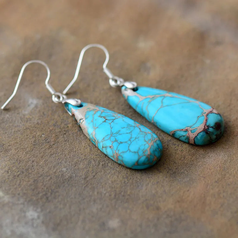 Natural stone copper teardrop earrings with intricate detailing, featuring a polished teardrop shape and warm metallic finish.