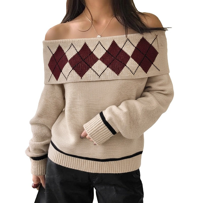 Beige off-the-shoulder knit sweater with burgundy argyle pattern and black trim on cuffs and hem.