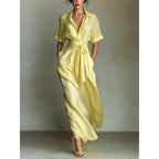 Women's solid color waist-slimming maxi dress with flip collar by FitiqueFit, featuring a fitted waist and flowing hem.