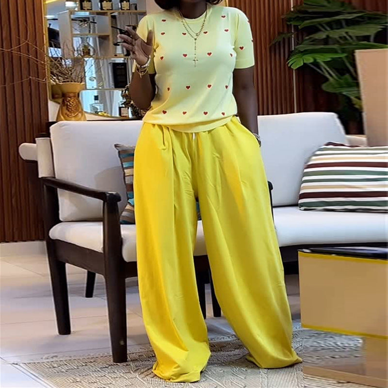 Heart print round neck top and wide-leg pants set by Plush Fashion Hub, featuring a cozy, stylish matching outfit.