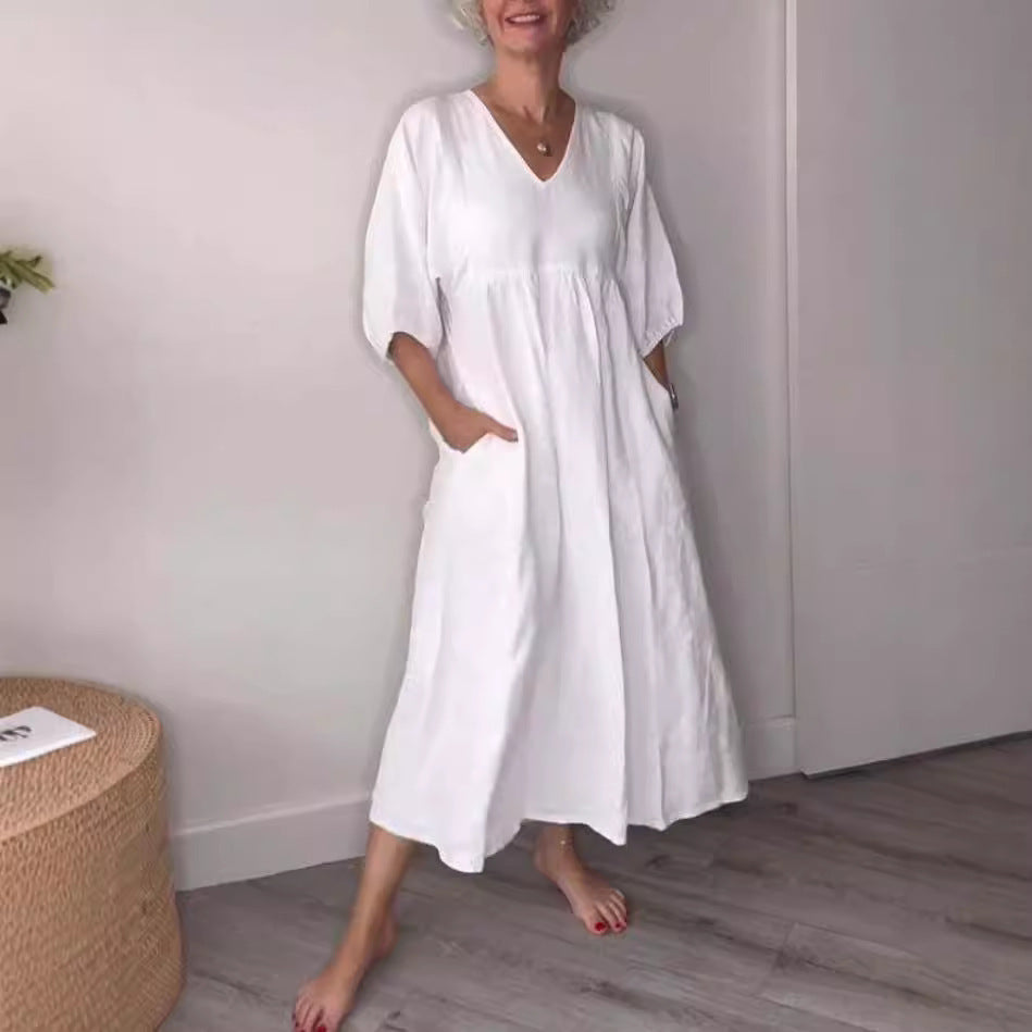 Deep V-neck pleated solid color pocket dress by eprolo, showing a stylish dress with pleats and front pockets on a white background.