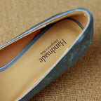 Close-up of a blue genuine leather stiletto heel interior with a tan insole marked "Handmade, Designed in Italy."