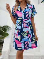 Women's colorful tropical print shirt dress by Plush Fashion Hub featuring button front, short sleeves, collar, and A-line midi style.