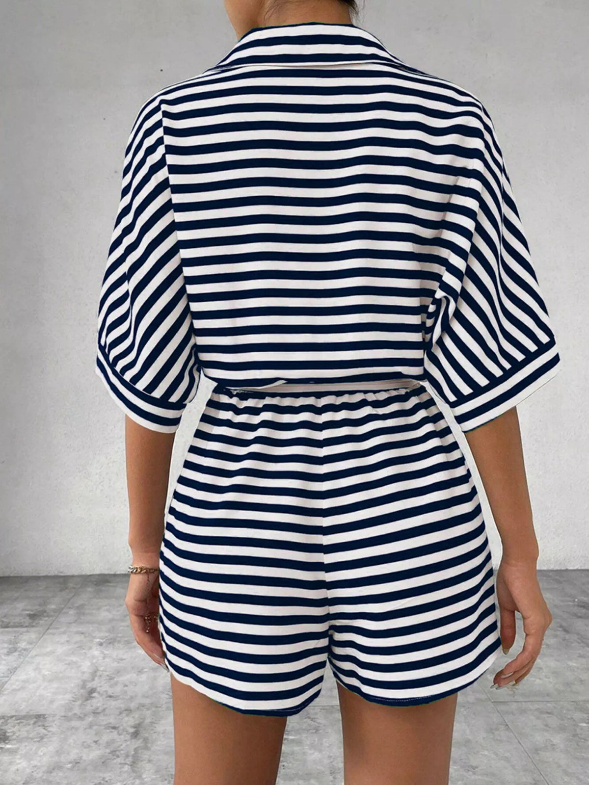 Striped button front half sleeve romper shirt by Plush Fashion Hub, featuring a casual design and front buttons in a stylish pattern.