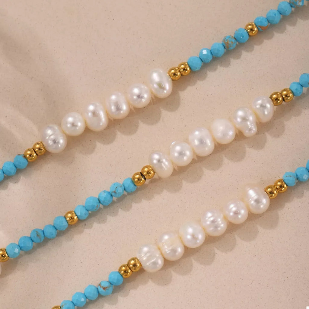 Turquoise pearl beaded necklace by Shopimist featuring multiple strands of shiny turquoise pearls and silver clasp.