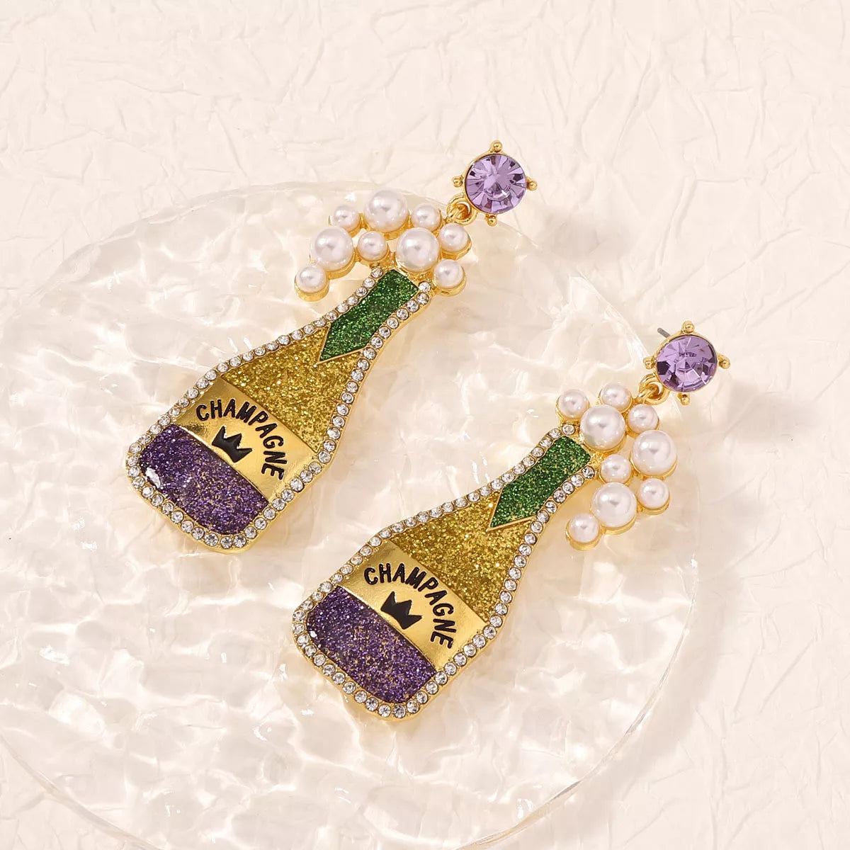 Champagne bottle earrings with pearls from Plush Fashion Hub, stylish jewelry accessory for fashion-forward outfits.