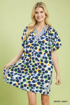 Umgee polka dot print tunic dress with long sleeves and relaxed fit, featuring a classic black and white pattern.