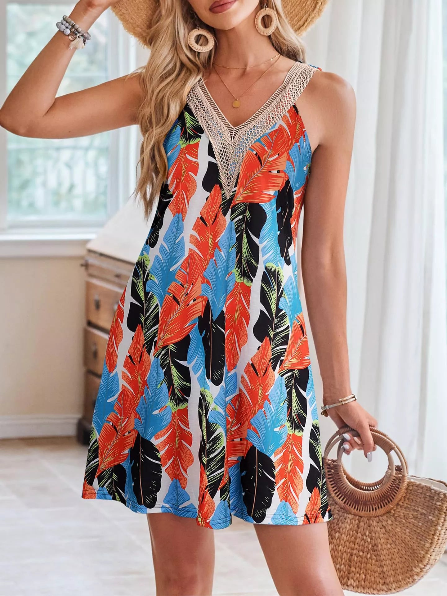 Tropical leaf print sleeveless V-neck dress by Plush Fashion Hub, featuring vibrant greenery on lightweight fabric.