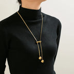 18K gold-plated titanium steel hollow bead necklace with smooth round beads and a shiny finish on a white background