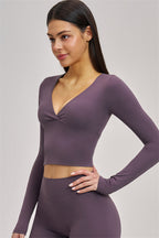 Fitglutes Activewear Swoon long sleeve crop top, black athletic shirt with fitted design, perfect for gym and workout sessions.