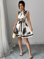 Sleeveless ruched printed tie waist dress by Shopimist featuring a fitted bodice and flowing skirt in vibrant floral print.