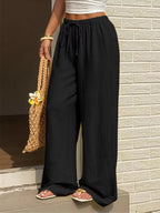 Plus size high-waisted wide-leg pants from Shopimist, shown in black fabric with a relaxed fit and wide-leg silhouette.