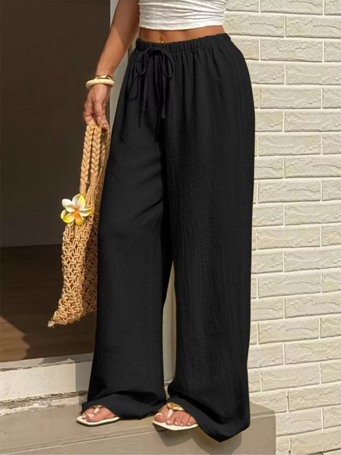 Plus size high-waisted wide-leg pants from Shopimist, shown in black fabric with a relaxed fit and wide-leg silhouette.