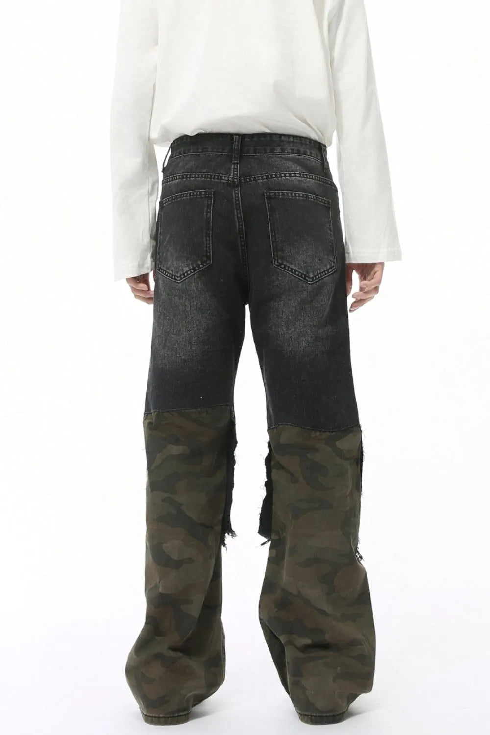 Distressed camouflage patchwork jeans by Trendsi featuring ripped details and a rugged, stylish camo design.